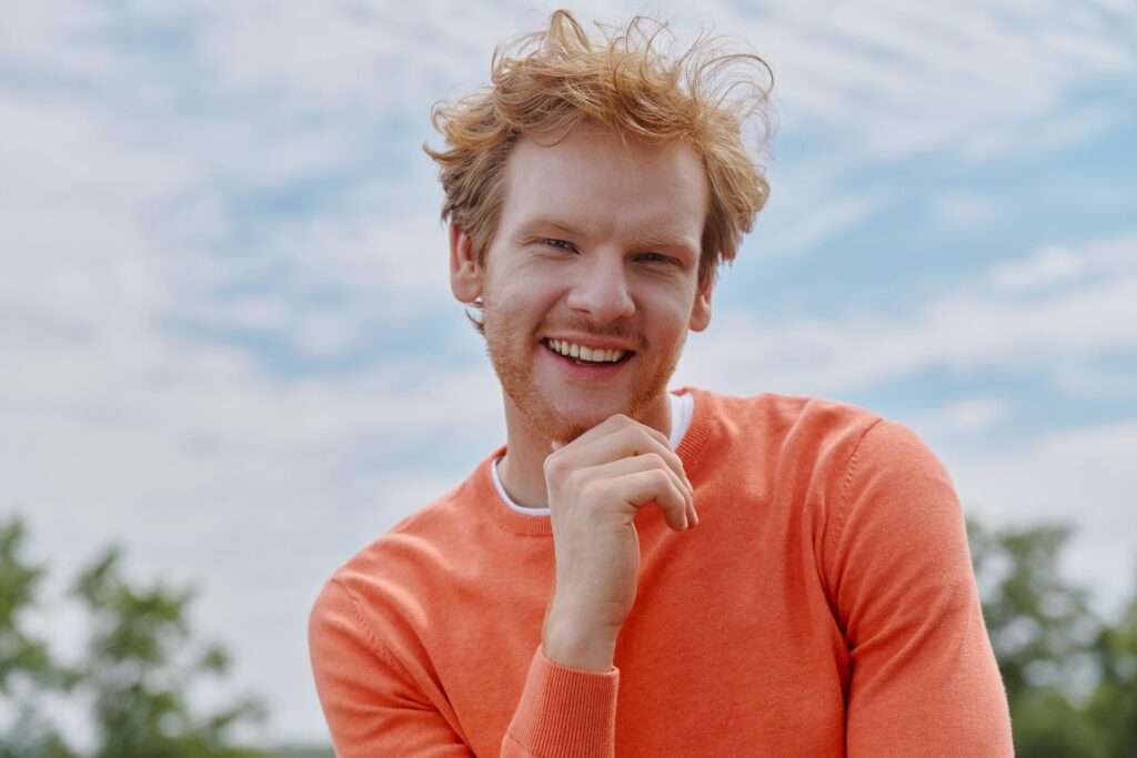 Ginger man in an orange jumper