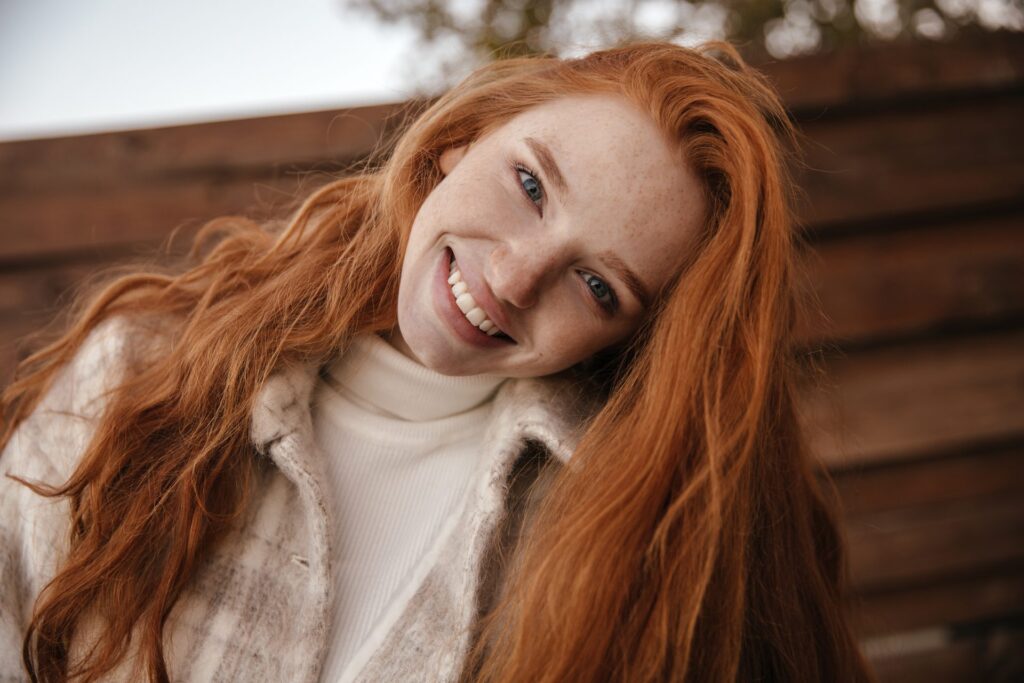 Smiling woman with long red hair
