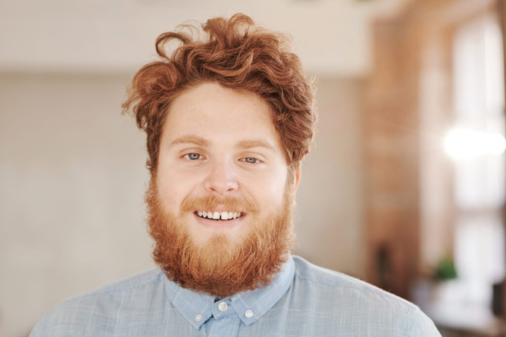 Man with curly red hair and a beard